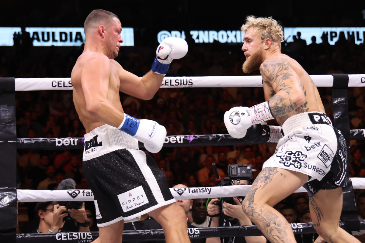 Nate Diaz and Jake Paul share the ring inside the American Airlines Center in Dallas, Texas.